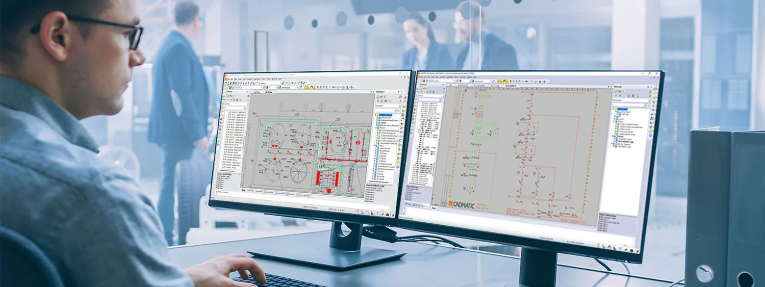 Person working at a desk with dual monitors displaying electrical schematics and CAD interfaces for intelligent data management.