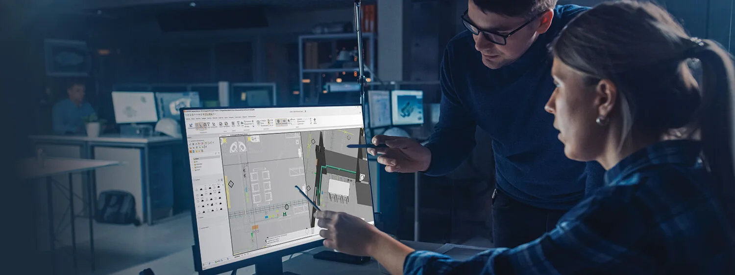 Two people working on CADMATIC Electrical software showing new UI with schematic layout and toolbar in an engineering workspace