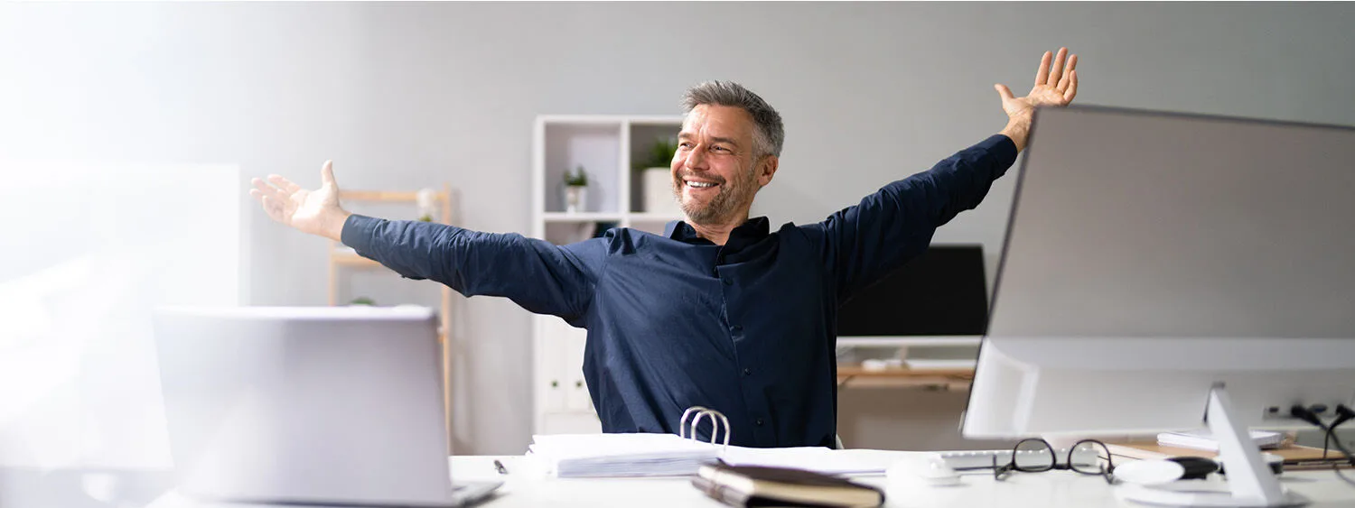 Engineer in a home office and hands spared apart smiling using Data Management for Process Industries