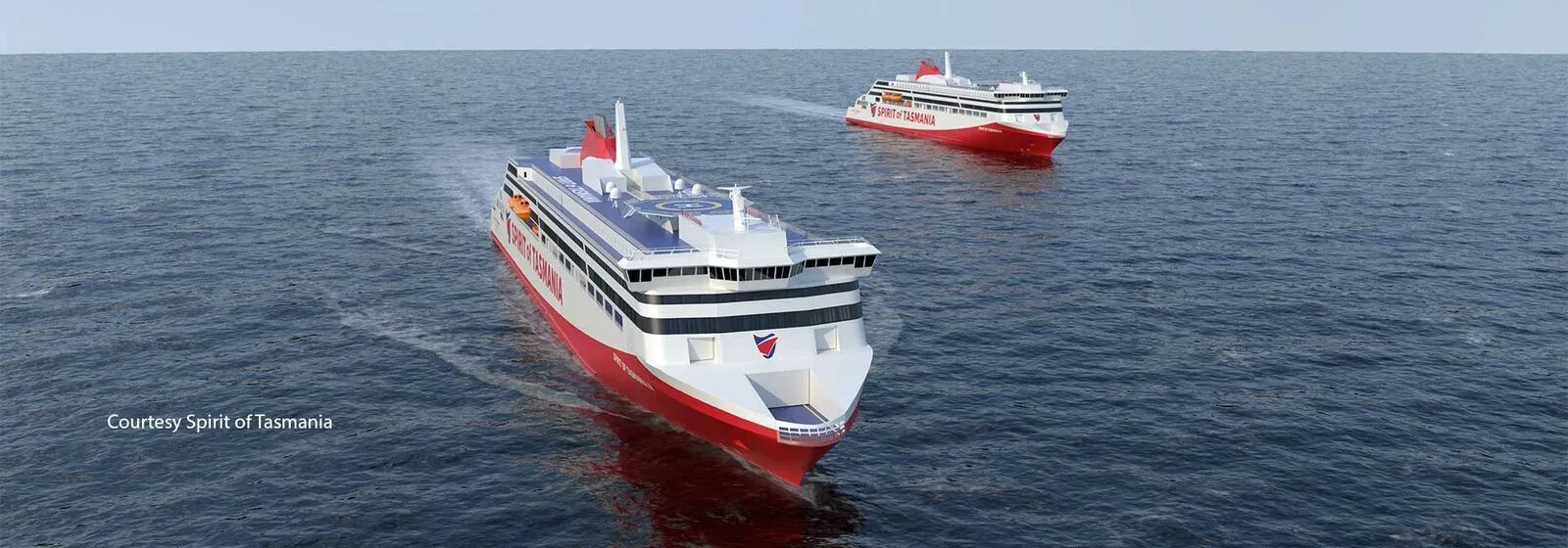 Kaksi punavalkoista matkustaja-autolauttaa "Spirit of Tasmania" purjehtii valtamerellä, yksi lautta etualalla ja toinen taustalla.