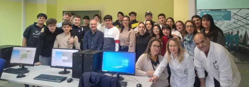 A group of young engineers in a room with computers