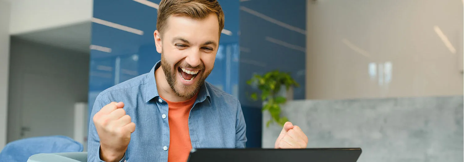 An engineer laughing working on his computer
