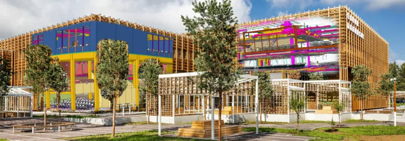 Modern building complex with wooden framework, colorful facades, landscaped areas, and outdoor seating at Tallinn Pelgulinn State Gymnasium