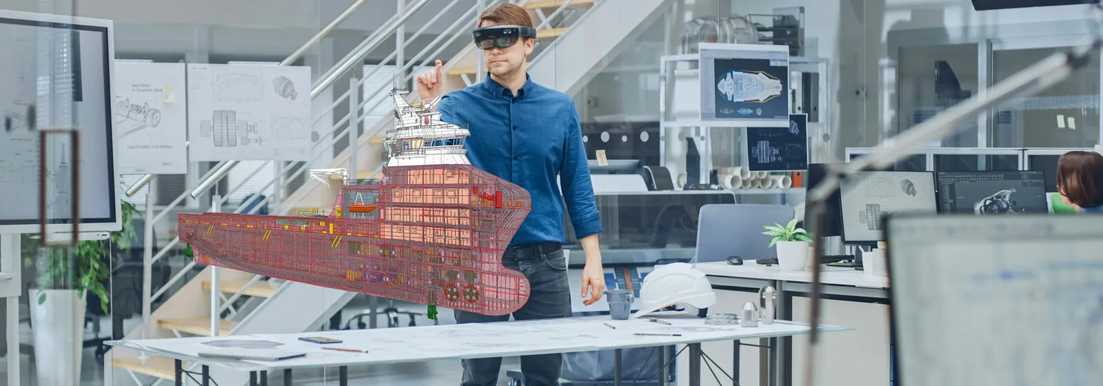 A man standing in front of a model of a ship