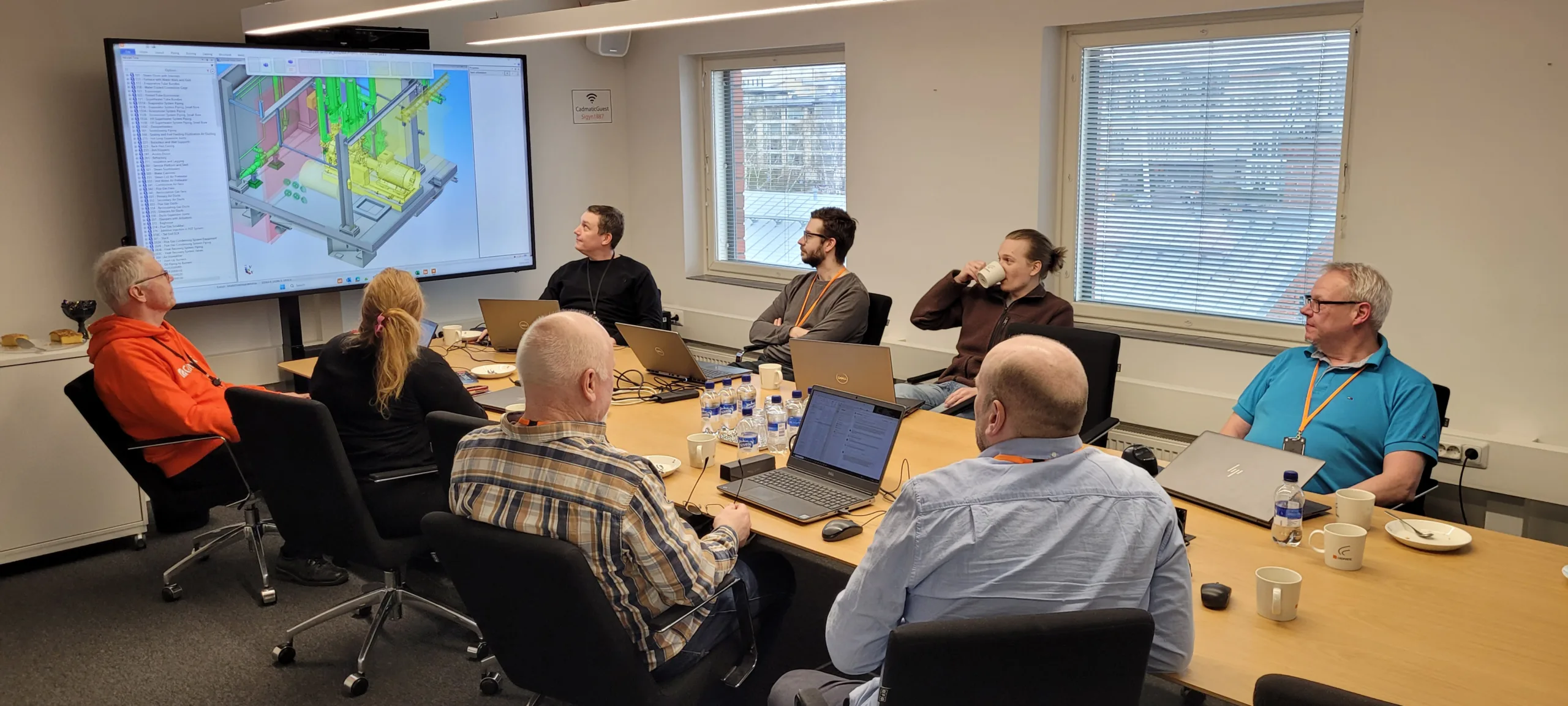 Cadmatic and Sumito team members view and discuss