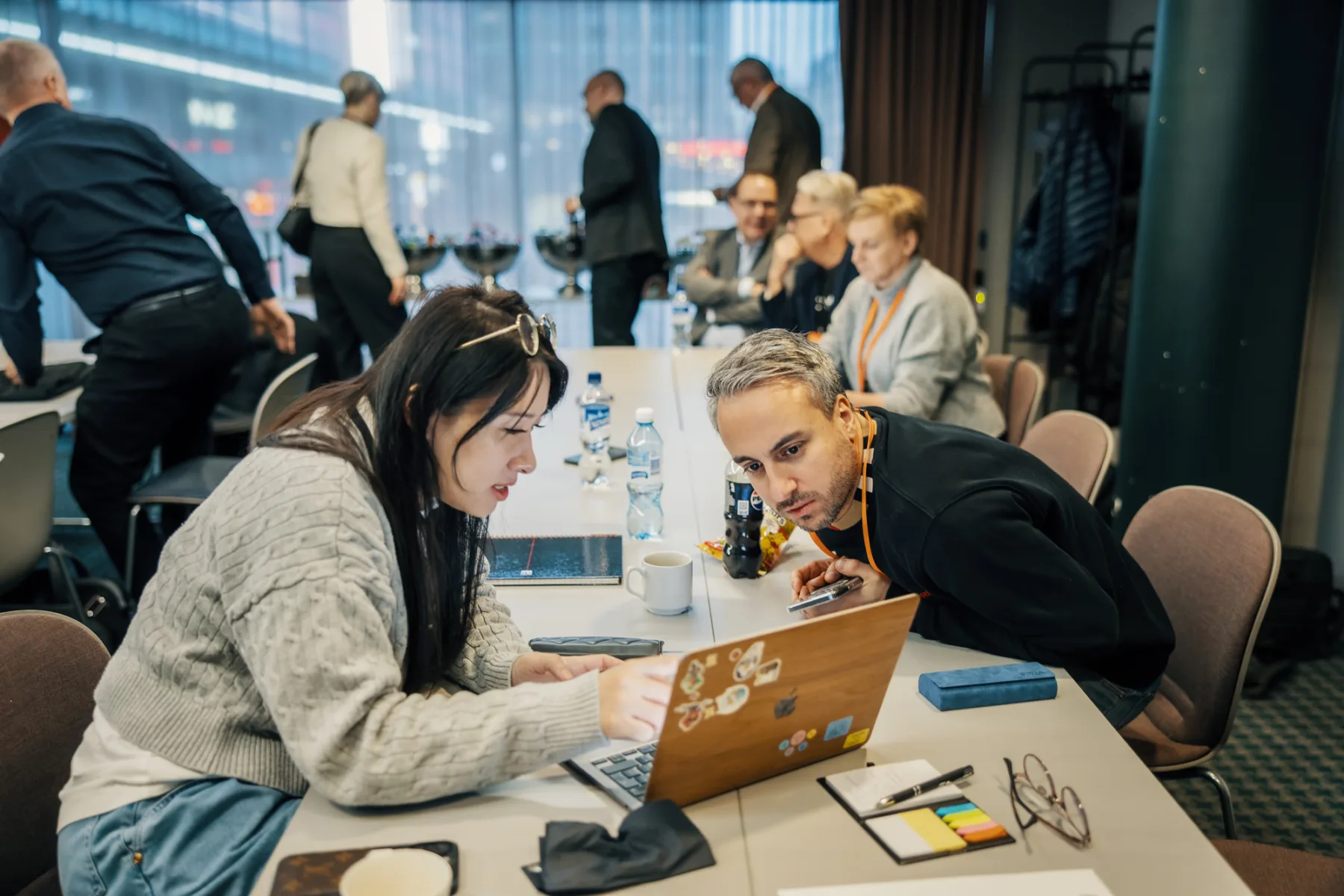 Cadmatic team members looking at a laptop screen