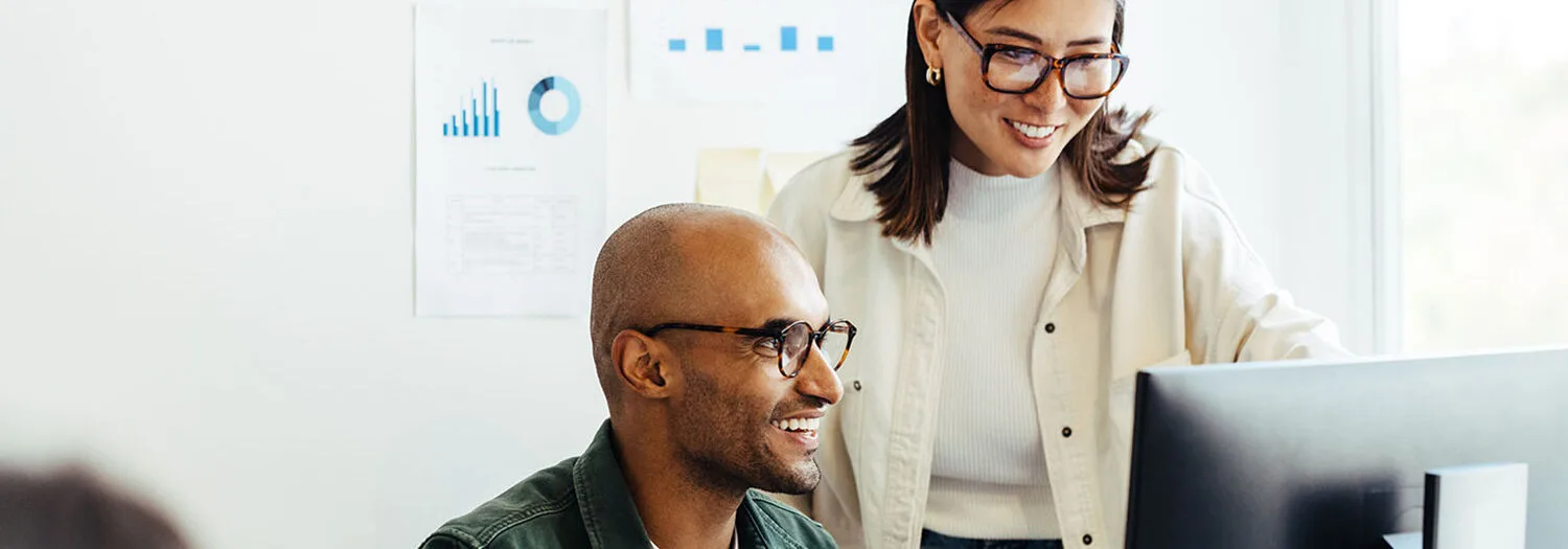 Man and woman watching computer screen