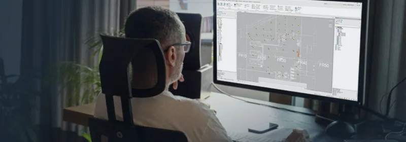 Person working on CADMATIC Electrical software showing labeled electrical layout with sections like FR10, FR30, and FR50