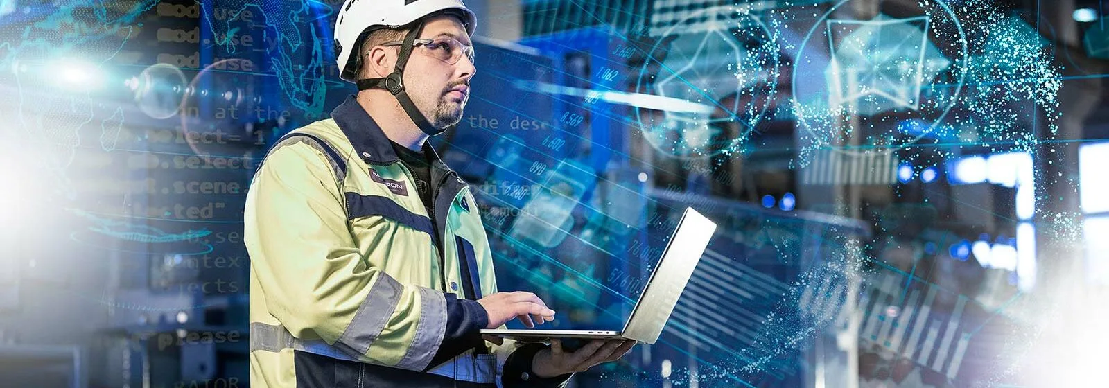 Industrial worker in safety gear using laptop in high-tech environment with digital overlays and data visualizations