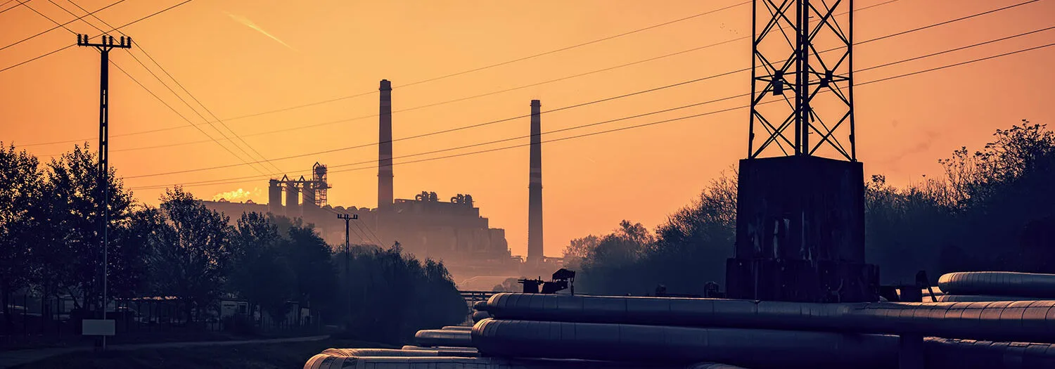 Energy plant at sunset and electricity cables