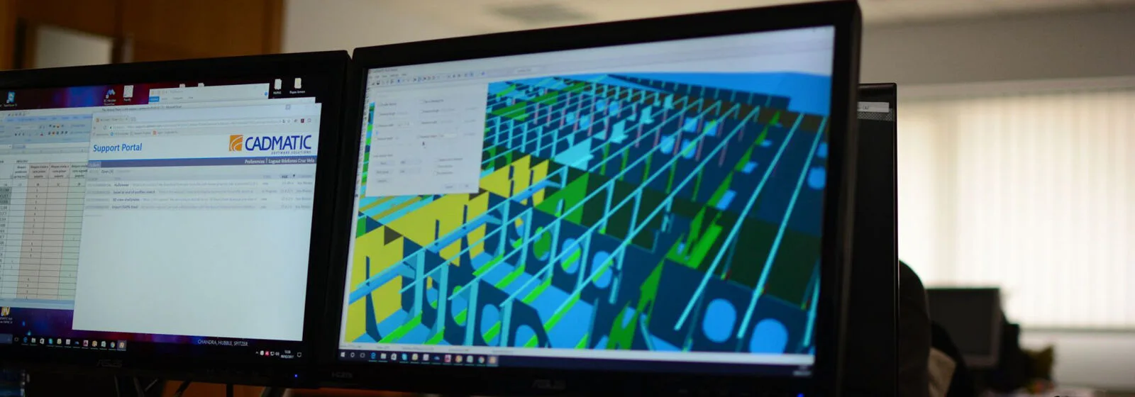 Two monitors on a desk showing a CADMATIC Support Portal webpage and a 3D ship structural model in CAD software