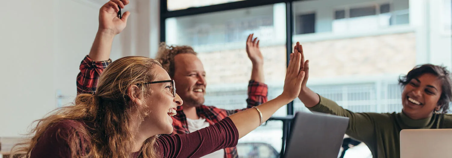 Engineers happy in the office clapping and applauding