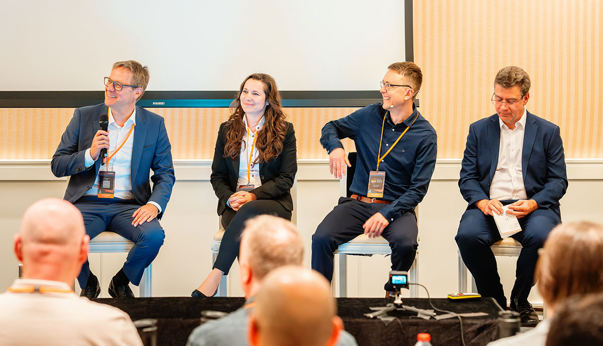 The Cadmatic team, including the CEO, are sitting on stage at the Cadmatic Digital Wave Forum 2025