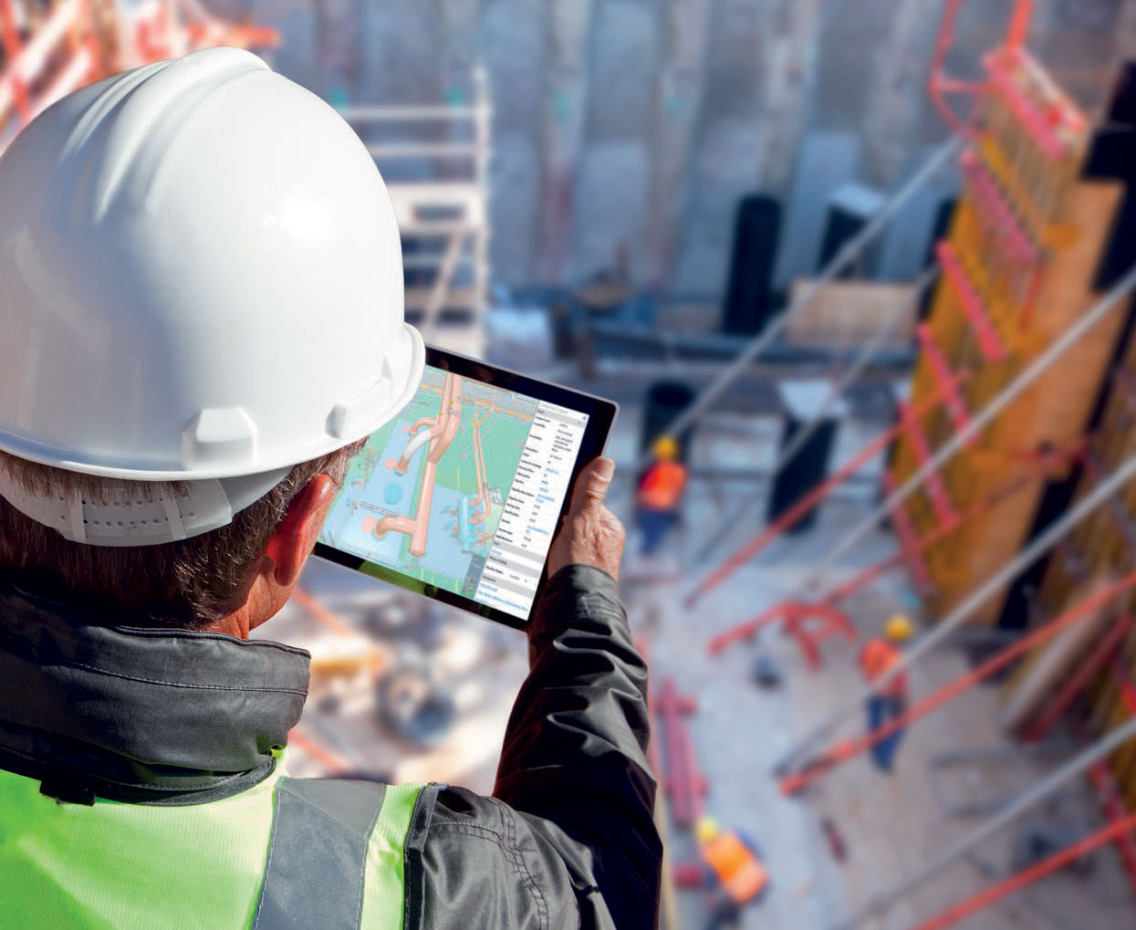 An engineer is using a tablet to display a 3D model, while a construction site is visible in the background.