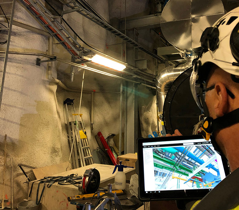 Construction man holding tablet in construction site