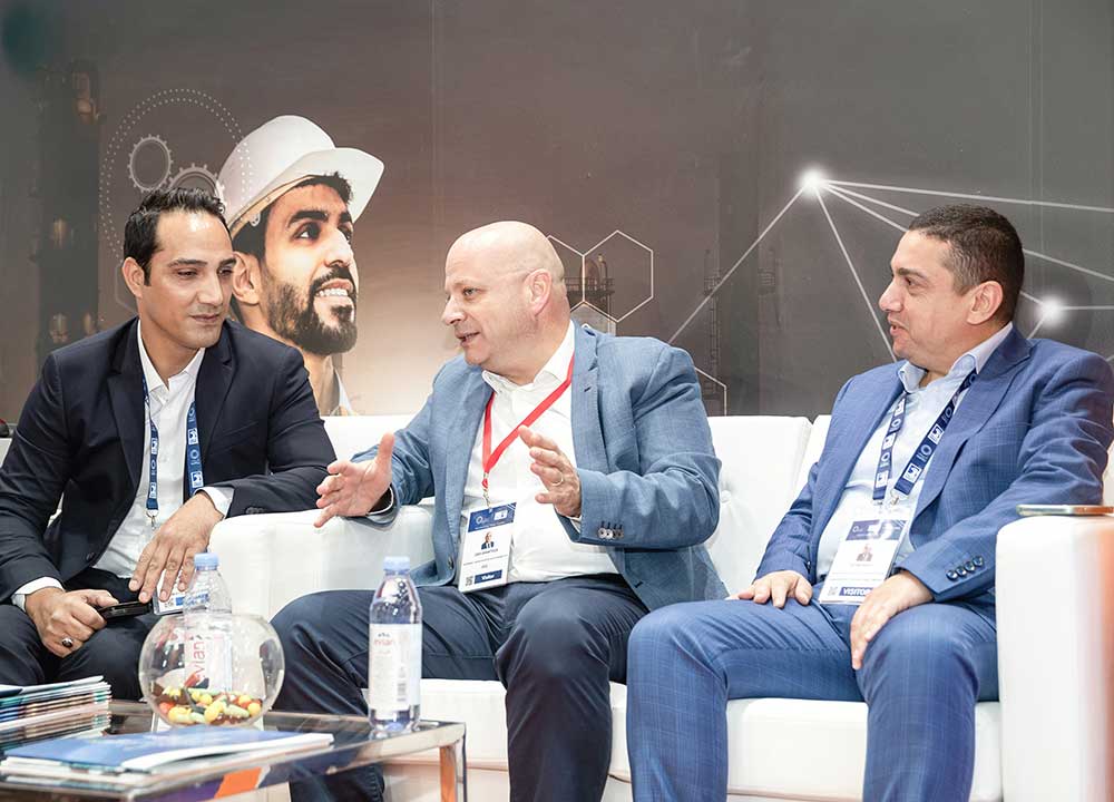 Three men sitting and discussing