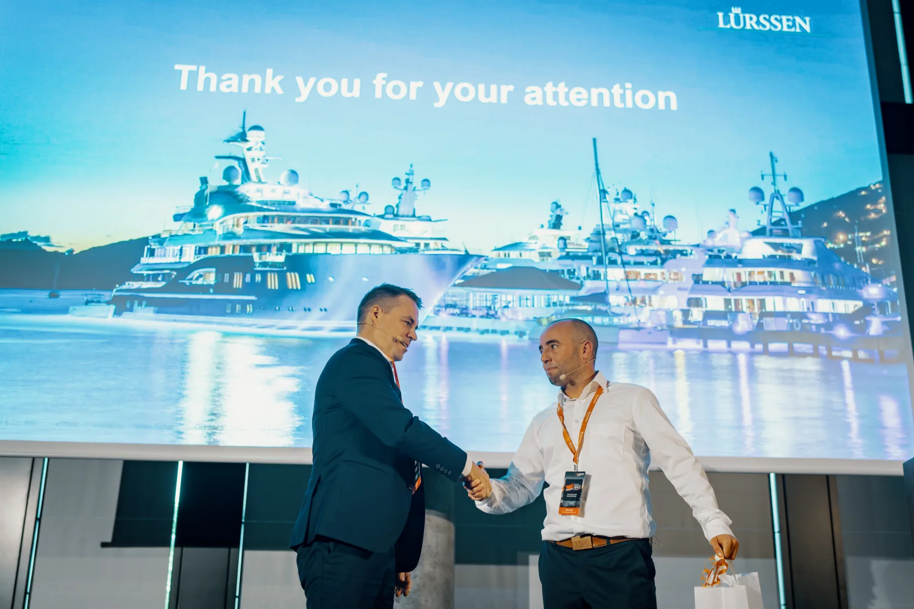 Niklas Nebel, Production Planner at Lürssen-Kröger shakes hands with Toni Renberg from Cadmatic at the Cadmatic Digital Wave Forum.